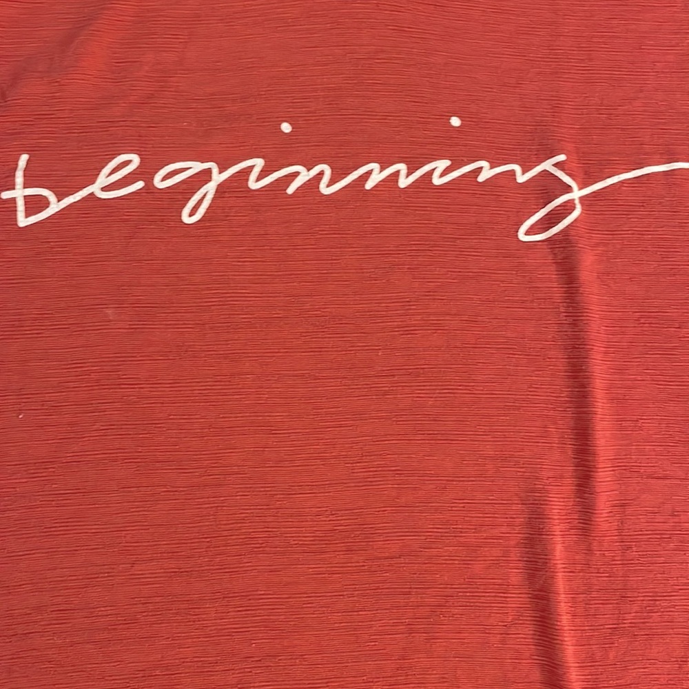 Fall Colored Blouse with White Cursive Writing Saying, “Beginning”
